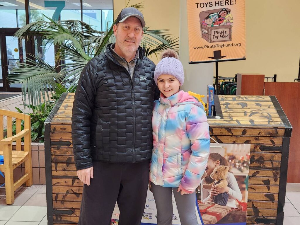 Jason Colline donating Christmas toys with his daughter two weeks before undergoing a liver transplant.